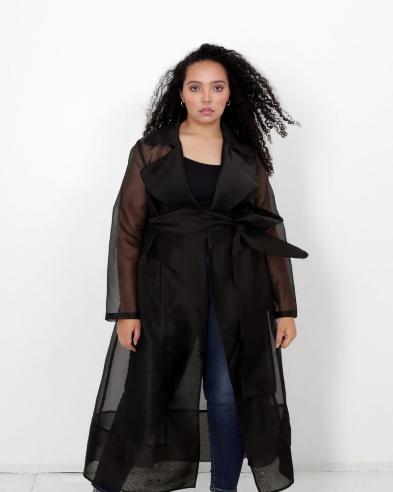 Front of a model wearing a size L Cherish Belted Trench Duster in Midnight Black by LuvMeMore. | dia_product_style_image_id:266613